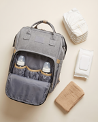 Nestcarry backpack with baby travel essentials flat lay